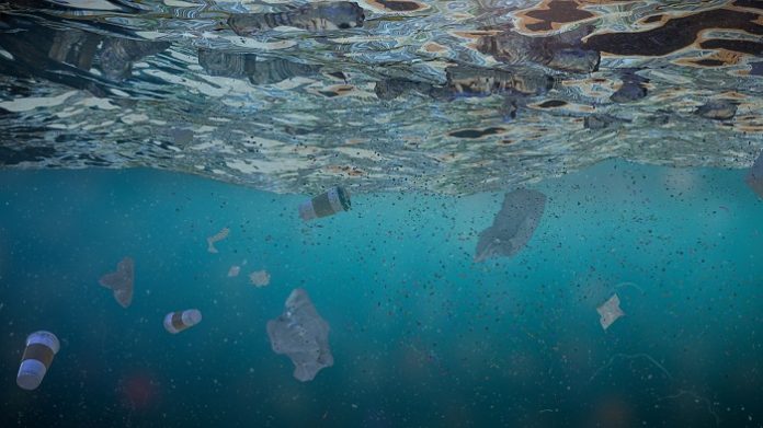 plastic pollution in ocean water, bottles floating in the current
