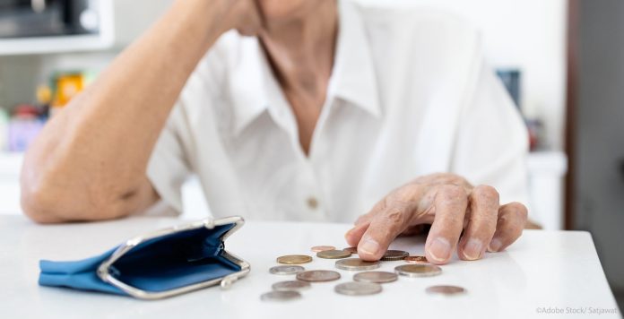 Stressed senior woman is counting remaining coins from pension,o